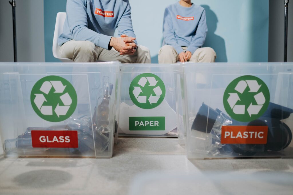 The Environmental Impact of Recycling Materials 2 Person sitting on the chair near the plastic containers with lables